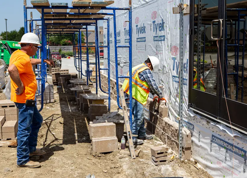 Modular building section has been set into place, and exterior masonry being applied